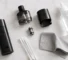 Cleaning a vape device: disassembled pod, coil, and cotton swab on a clean surface